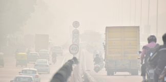 People,Pass,Through,The,Rising,Air,Pollution,On,The,Delhi-jaipur,Expressway.